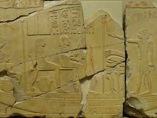 An ancient Egyptian relief sculpture depicting a high-ranking official and his wife on a ritual pilgrimage. The artwork dates back to the Late Period (Twenty-Sixth Dynasty), during the reign of Pharaoh Psammetichus I.