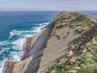 Coastal landscape at Cabo Mayor, Santander, showing steep slopes shaped by erosion.